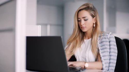 Happy Businesswoman Working on Her Laptop in the Office