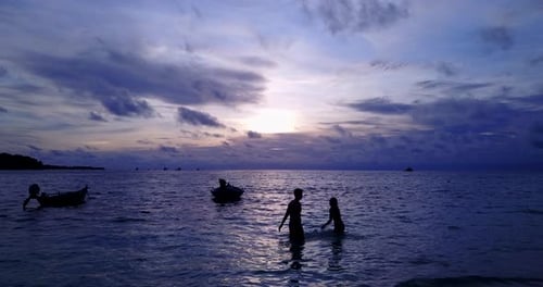 Romantic couple on honeymoon vacation have fun on beach on summer white sandy 4K background