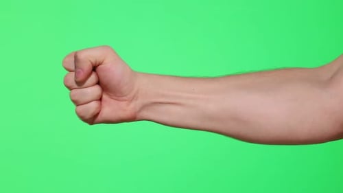 Beat male hand on green screen, chroma key