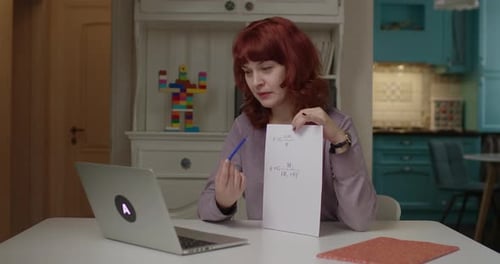 Woman Explaining Physics Formula at Home