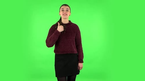 Young Cheerful Woman Showing Thumbs Up, Gesture Like. Green Screen