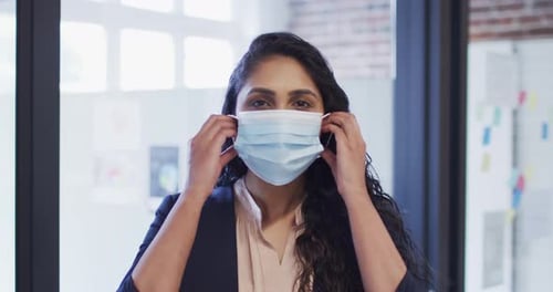 Portrait of woman wearing face mask at office
