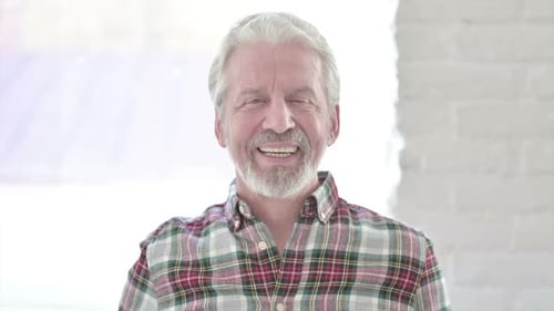 Senior Man Smiling and Waving Hello