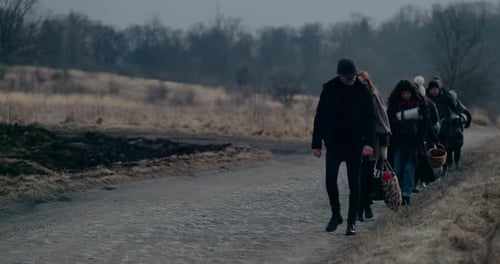 War Immigrants With Luggage Walking On Road
