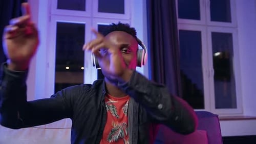 Young Adult Dancing Happily with Headphones