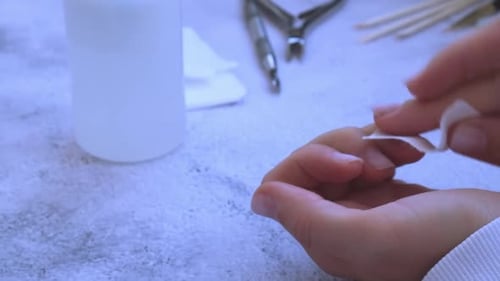 Woman Cleaning Nails With Cloth Close Up