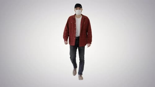 Young Adult Wearing Face Mask Walking toward Camera