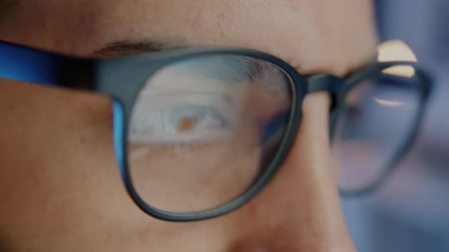 Closeup Slow Motion Portrait of Male Employee Wearing Glasses Working Late in Office
