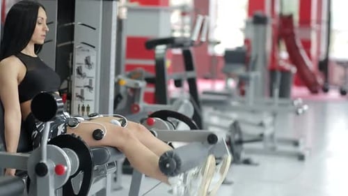A Young and Athletic Woman Performs Active Exercises to Strengthen the Muscles the Lady is in the