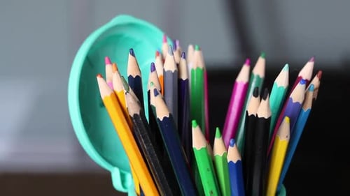 Colored Pencils For Drawing. They Stand In A Pencil Holder In The Form Of A Trash Can