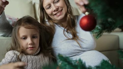 Child Together With Pregnant Woman Mother Dress Up Christmas Tree