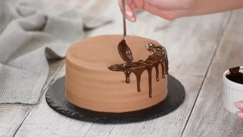 Chocolate Cake Being Decorated with Drizzled Chocolate