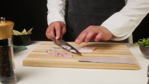 Person Cutting Fresh Fish on Cutting Board