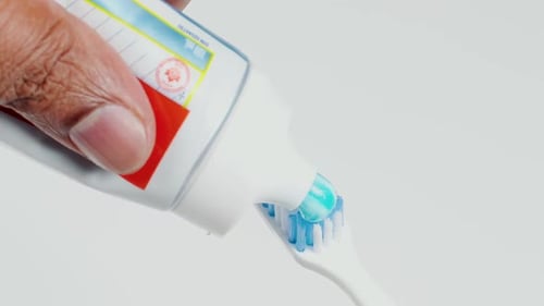 Blue Toothpaste Onto Tooth Brush