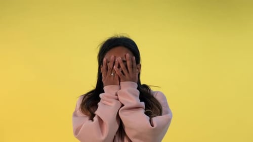 Woman Displays Range of Expressions on Yellow Backdrop