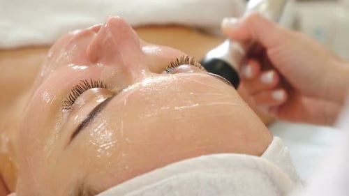Woman Receiving Professional Hydrating Facial Treatment