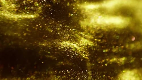 Goldene Tinte bei Wasseraufnahmen mit Hochgeschwindigkeitskamera. Goldene Farbtropfen fallen gelassen, reagieren, kreieren