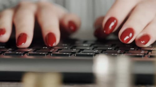 Typing on Keyboard with Coins in Foreground