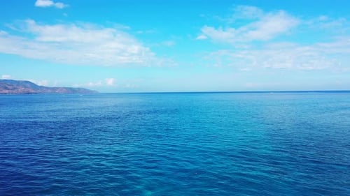 Tropical fly over abstract shot of a sunshine white sandy paradise beach and aqua turquoise water