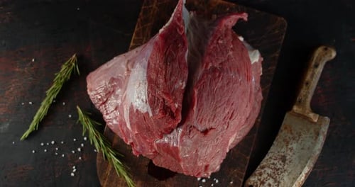 Raw Red Meat on Wooden Cutting Board