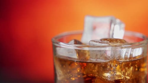 Cola with Ice Cubes Rotate Close-up