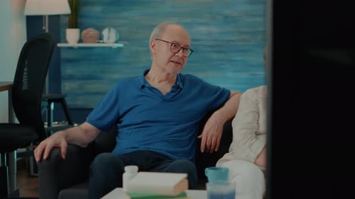 Senior Couple Relaxing and Watching Television