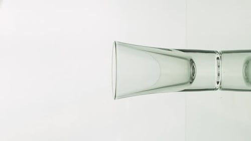 Water Being Poured From Glass Into Clear Cup
