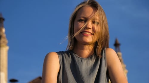 Young Blonde Woman Smiles in City