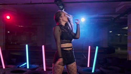 Stylish Woman Dancing in Urban Night Setting