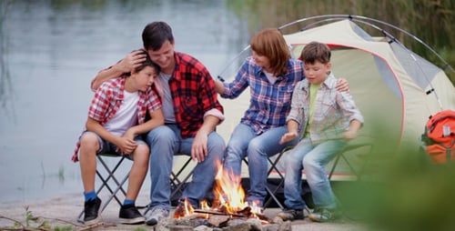 Family Camping By the Lake With a Tent