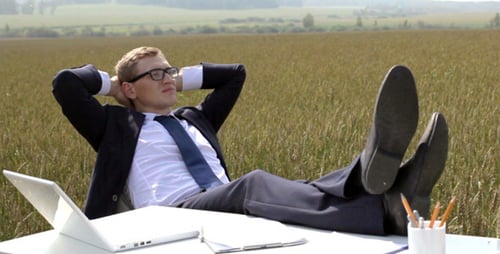 Young Adult Relaxing at Desk in Wheat Field