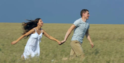 Couple Runs Joyfully Through Golden Wheat Field