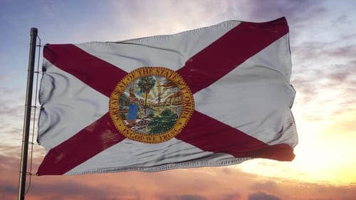Realistic Florida State Flag Waving Against Beautiful Sunset Sky