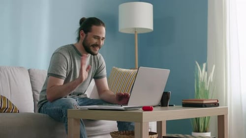 Man Having Video Call On Laptop at Home