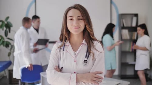 Confident Woman Doctor in Hospital Office Smiling