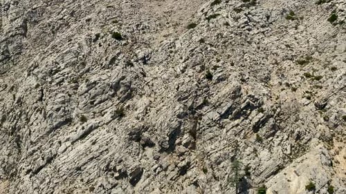 Top view of beautiful natural rocky sandy mountains with rare green trees growing on the rocks. High