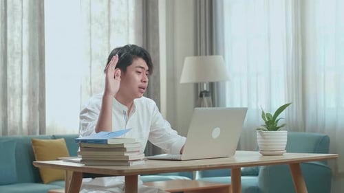 Young Man Talking During Video Call on Laptop
