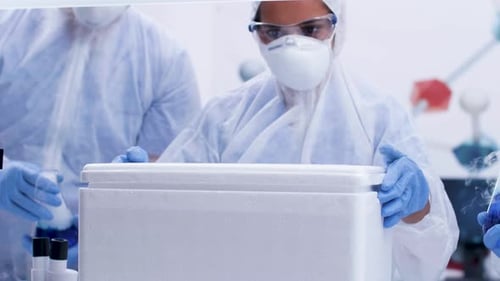 Female Scientist Opening a Refrigerator Box in Modern Science Laboratory