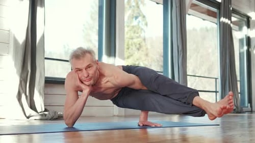 Man Holds Impressive Yoga Pose in Sunny Room