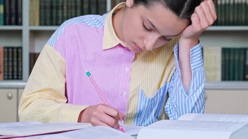 Teenage Girl Student Studying in the School Library