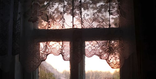 Lace Curtains in Window During Sunrise