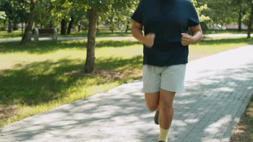 Overweight Man Running in Park