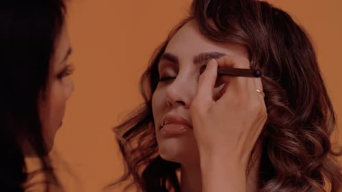 Makeup Artist Applying Eye Makeup to a Woman