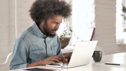 Adult Man Frustrated While Using Laptop