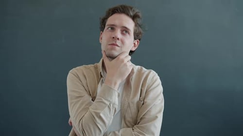 Young Adult Man Thinking with Hand on Chin