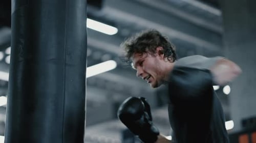 Candid Kickboxer Training at Gym. Focused Sportsman Boxing in Sport Club