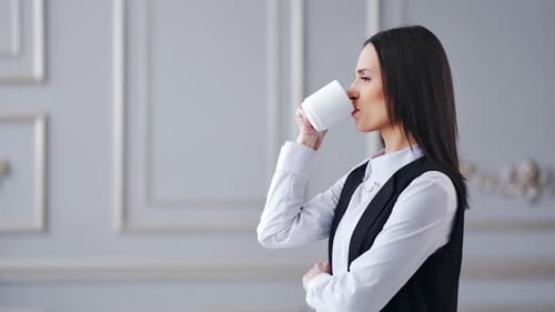 Side View Successful Stylish Business Woman Drinking Coffee at Luxury Interior
