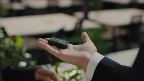 Auto Seller Giving Car Key To Female Buyer Indoor Cropped