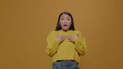 Surprised Woman with Big Eyes Feeling Astonished in Studio