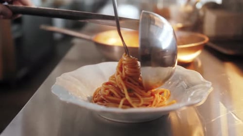 Chef Plates Spaghetti in a Commercial Kitchen